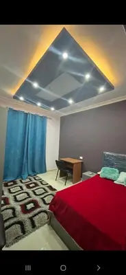 a bedroom with a red bed and a table at GZ Resort in Hurghada