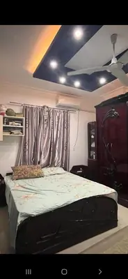 a bedroom with a bed with a curtain and aintendent at GZ Resort in Hurghada