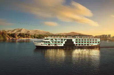 a cruise ship is docked on the water at Acamar Nile Cruise - Every Monday from Luxor for 04 & 07 Nights - Every Friday From Aswan for 03 & 07 Nights in Luxor