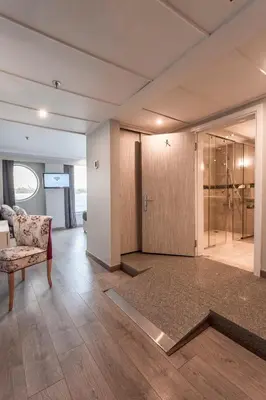 a living room with a couch and a glass door at Acamar Nile Cruise - Every Monday from Luxor for 04 & 07 Nights - Every Friday From Aswan for 03 & 07 Nights in Luxor