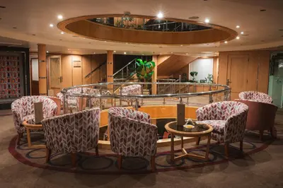 a waiting room with chairs and a table and a spiral at Acamar Nile Cruise - Every Monday from Luxor for 04 & 07 Nights - Every Friday From Aswan for 03 & 07 Nights in Luxor