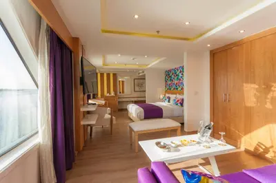 a hotel room with a bed and a table at Acamar Nile Cruise - Every Monday from Luxor for 04 & 07 Nights - Every Friday From Aswan for 03 & 07 Nights in Luxor