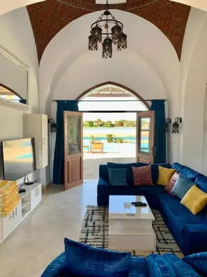 a living room with a blue couch and a table at Villa 3bedroom in new years in Hurghada