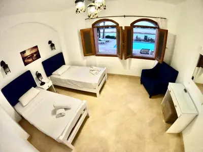 a room with a bed and a couch and a window at Villa 3bedroom in new years in Hurghada