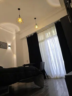 a living room with a couch and a large window at Cozy studio near by the beach - Intercontinental in Hurghada