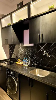 a kitchen with a sink and a washing machine at Cozy studio near by the beach - Intercontinental in Hurghada