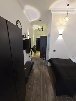 a hotel room with a bed and a hallway at Cozy studio near by the beach - Intercontinental in Hurghada