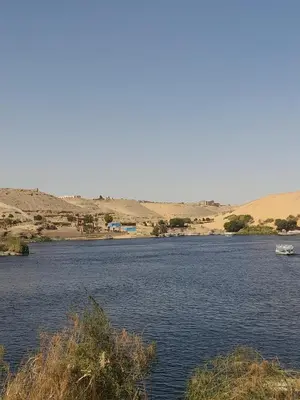 a body of water with a boat in the middle at waleed home in Jazīrat Aswān