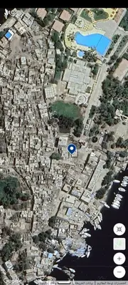 a map of a city with a blue arrow at waleed home in Jazīrat Aswān