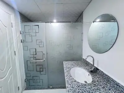 a bathroom with a sink and a shower with a mirror at سكانديك ريزورت - Scandic resort in Hurghada
