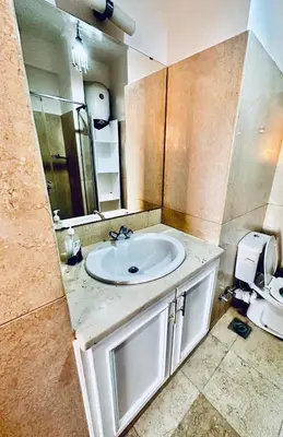 a bathroom with a sink and a mirror at 2Bedroom in west golf in Hurghada