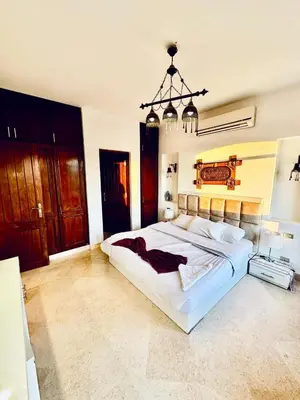 a bedroom with a large white bed with a chandelier at 2Bedroom in west golf in Hurghada