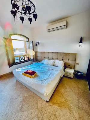 a bedroom with a large bed with a mirror at 2Bedroom in west golf in Hurghada