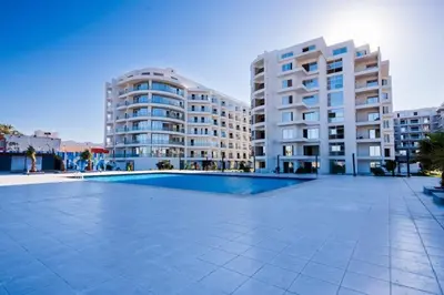 an empty swimming pool in front of two tall buildings at Scandic resort hurghada in Hurghada