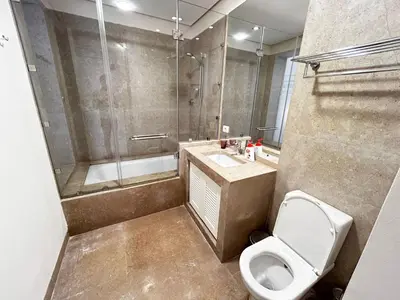 a bathroom with a shower and a toilet and a sink at luxury ancient stands resort one bedroom in Hurghada