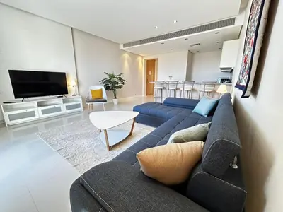 a living room with a couch and a tv at luxury ancient stands resort one bedroom in Hurghada