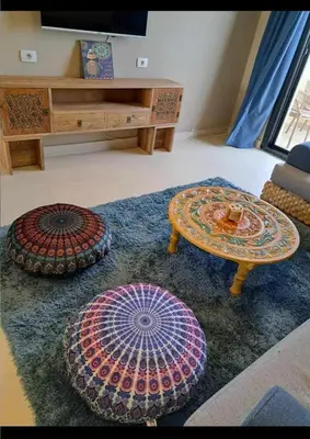 a living room with two tables and a couch at Makadi Heights in Hurghada