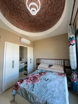 a bedroom with a bed with a circular ceiling at Makadi heights - phase 2 in Hurghada