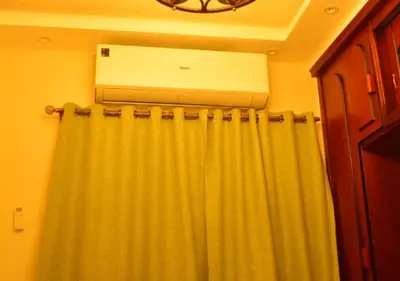 a air conditioner sitting on top of a shower curtain at Aton Apartment, Luxor Resort, Minutes from City Center in Luxor