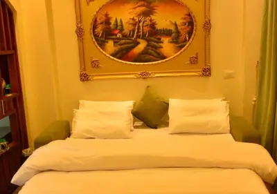 a bed in a room with a picture on the wall at Aton Apartment, Luxor Resort, Minutes from City Center in Luxor