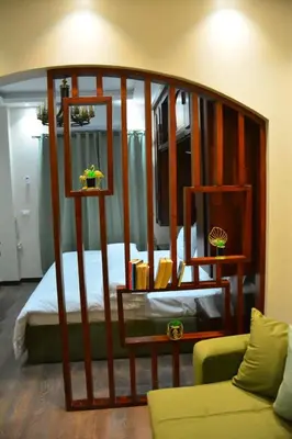 a bedroom with a bed with a wooden frame at Aton Apartment, Luxor Resort, Minutes from City Center in Luxor