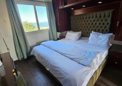 a bedroom with a large bed with a window at Aton Apartment, Luxor Resort, Minutes from City Center in Luxor