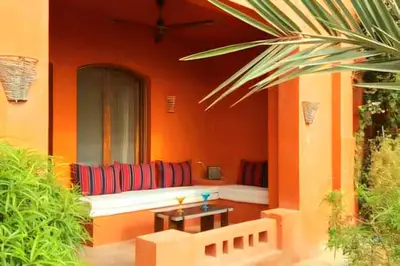 a porch with a couch in an orange wall at bedroom in west golf 1 in El Gouna