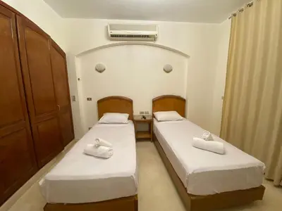 two beds in a small room with a heater at bedroom in west golf 1 in El Gouna