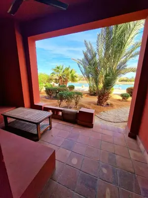 a patio with a bench and a view of the beach at bedroom in west golf 1 in El Gouna
