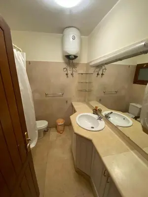 a bathroom with two sinks and a toilet at bedroom in west golf 1 in El Gouna