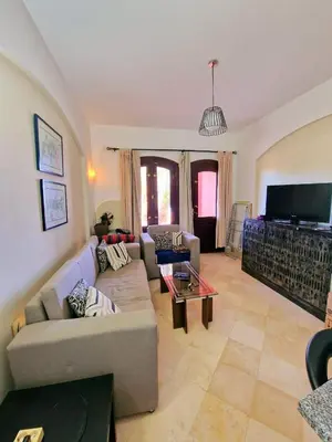 a living room with a couch and a table at bedroom in west golf 1 in El Gouna