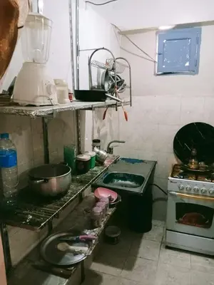 a dirty kitchen with a stove and a sink at الشواربي السياحي كورنيش النيل in Aswan