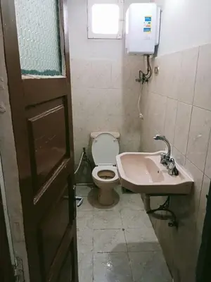 a bathroom with a toilet and a sink at الشواربي السياحي كورنيش النيل in Aswan