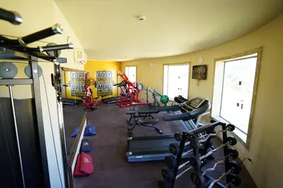 a gym with several tread machines in a room at UTOPIA Blue Resort in Quseir
