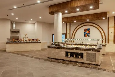 a restaurant with a counter in the middle of a room at UTOPIA Blue Resort in Quseir