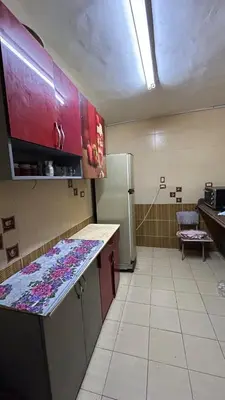 a kitchen with a counter top and a refrigerator at شقة في موا بلازا كورنيش النيل اسوان Apartment in Mowa Plaza Aswan Nile Corniche in Aswān
