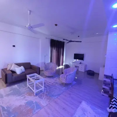 a living room with a couch and chairs and a table at Banana Guest House in Luxor