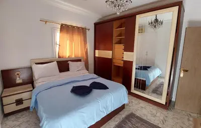 a bedroom with a bed and a large mirror at Hurghada Concierge at St Paul building 3 bd in Hurghada