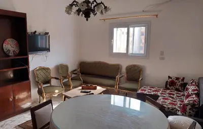 a living room with a table and chairs at Hurghada Concierge at St Paul building 3 bd in Hurghada