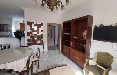 a living room with a dining room table and a television at Hurghada Concierge at St Paul building 3 bd in Hurghada