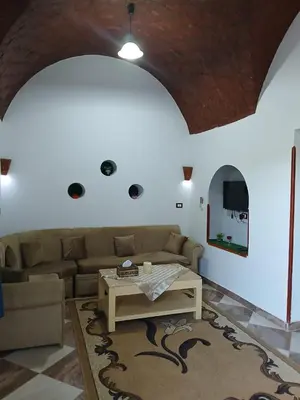 a living room with a couch and a table at Nile Rose Hause in Al Karnak