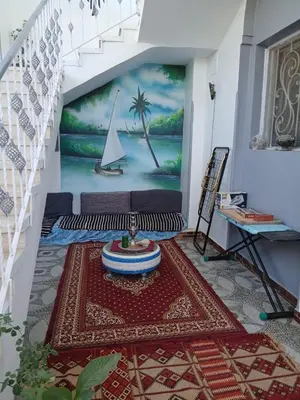 a living room with a mural of a sailboat at Nile Rose Hause in Al Karnak