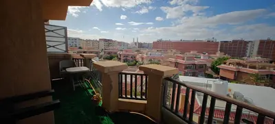a balcony with a view of a city with buildings at Turtles beach resort ED Seaview Apartment in Hurghada