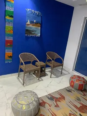 a room with two chairs and a blue wall at Fanadir Bay Resort, rental chalet apartment in Hurghadana in Hurghada