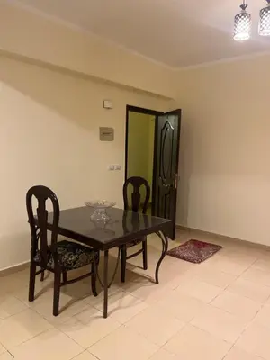 a dining room table with two chairs and a mirror at Central Hurghada Apartment in Hurghada