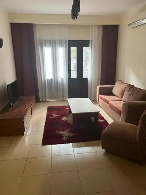 a living room with a couch and a coffee table at Central Hurghada Apartment in Hurghada