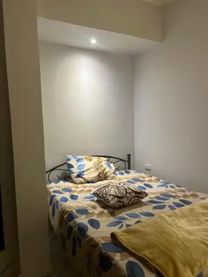 a bedroom with a bed with a comforter and pillows at Central Hurghada Apartment in Hurghada