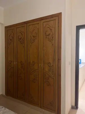 a pair of wooden cabinets in a room at Central Hurghada Apartment in Hurghada
