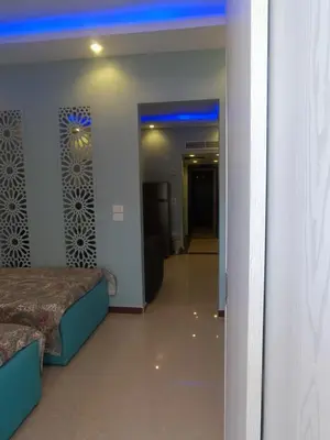 a room with a bed and a hallway with a door at Elite apartment private beach Holiday Chalet Free WIFI in Hurghada