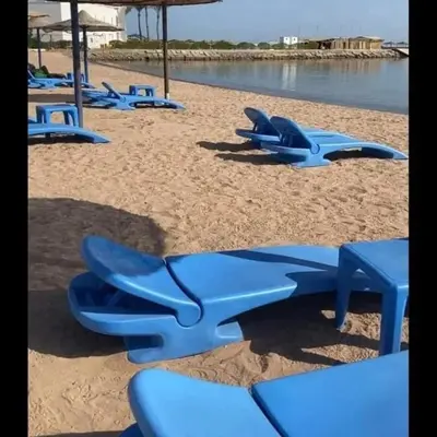 a group of blue chairs on the beach at Elite apartment private beach Holiday Chalet Free WIFI in Hurghada